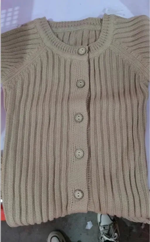 Baby long-sleeved knitted jumpsuit romper pullover in beige, size 80cm, lying flat on a white background