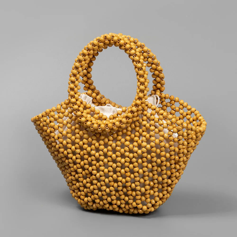 Hand-woven maple wooden bead beach bag in dumpling shape with hollow weave design