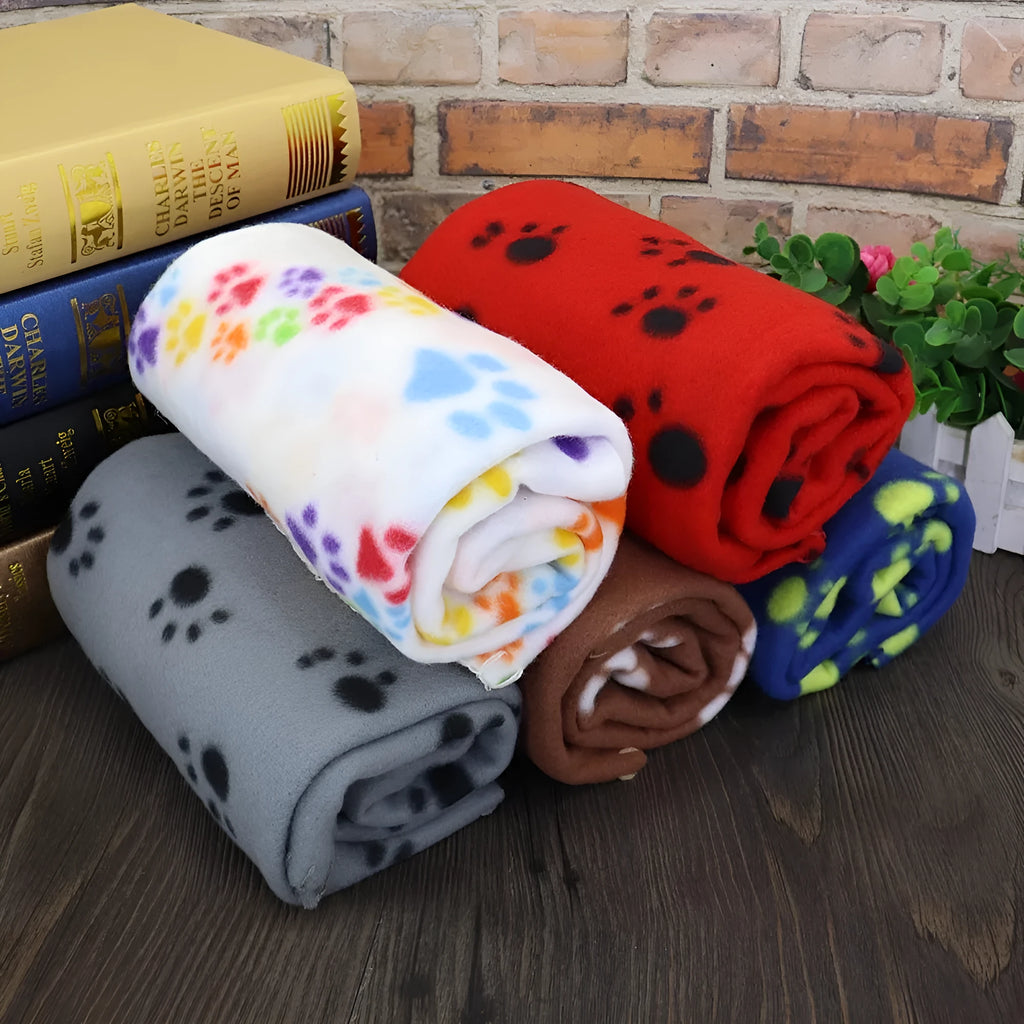 Pet warm blanket with paw print design double-sided fleece in blue colour, laid flat on a surface