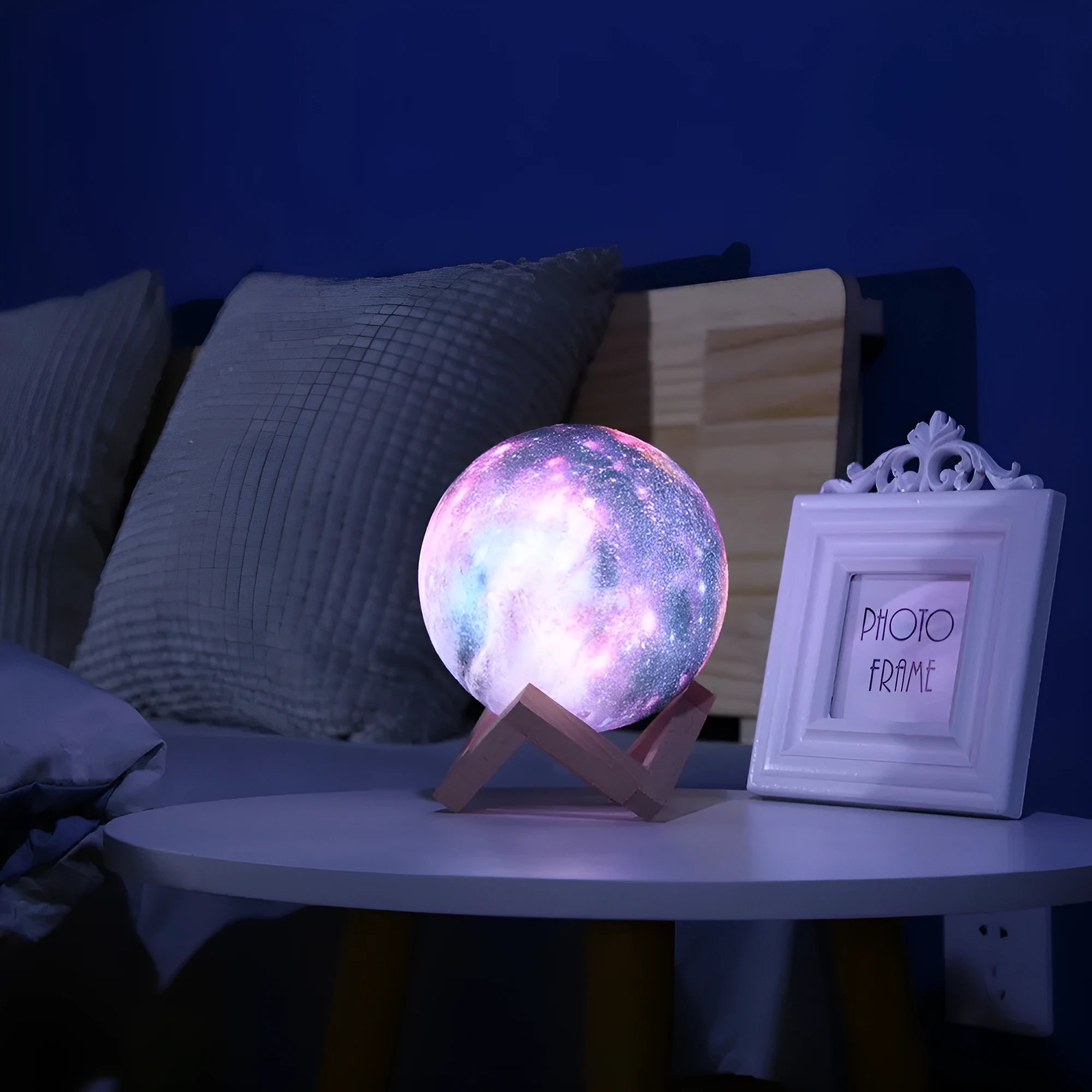 3D-printed white lunar sphere LED night light on a dark surface, showing touch and remote control.