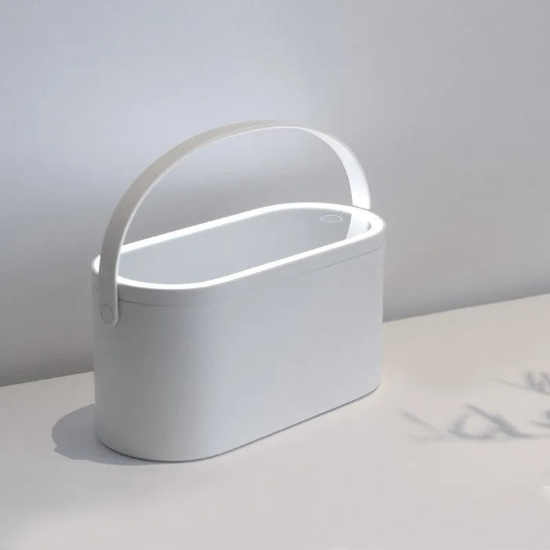 Pink portable makeup storage box with LED illuminated aluminium mirror and cosmetic compartments