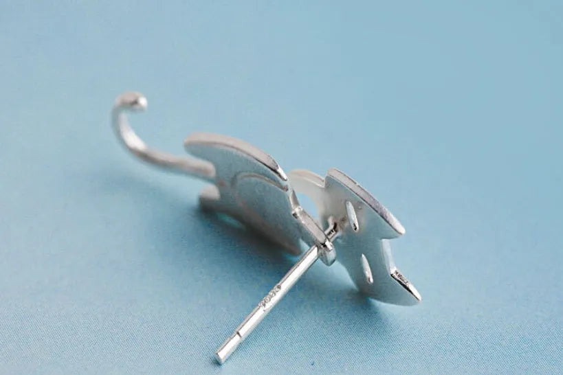 S925 sterling silver stud earrings with asymmetrical cat and fish design on white background