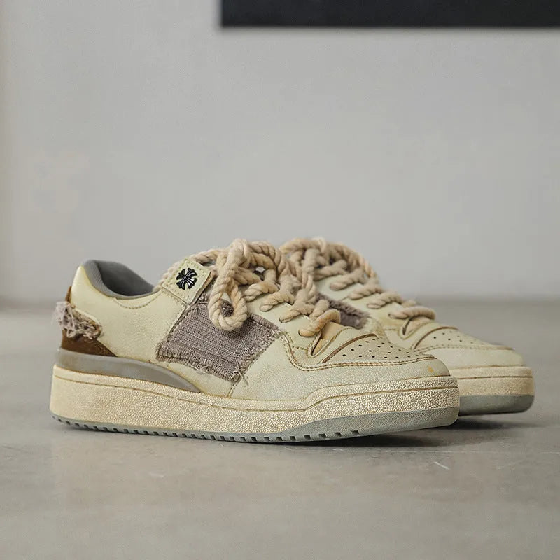 Beige low-top skateboard shoes with vintage patch design and rubber sole