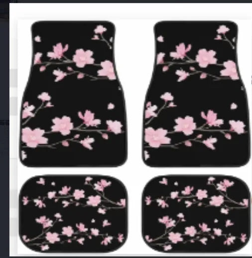 Black four-piece rubber car foot mat set with textured surface, shown on a car floor.