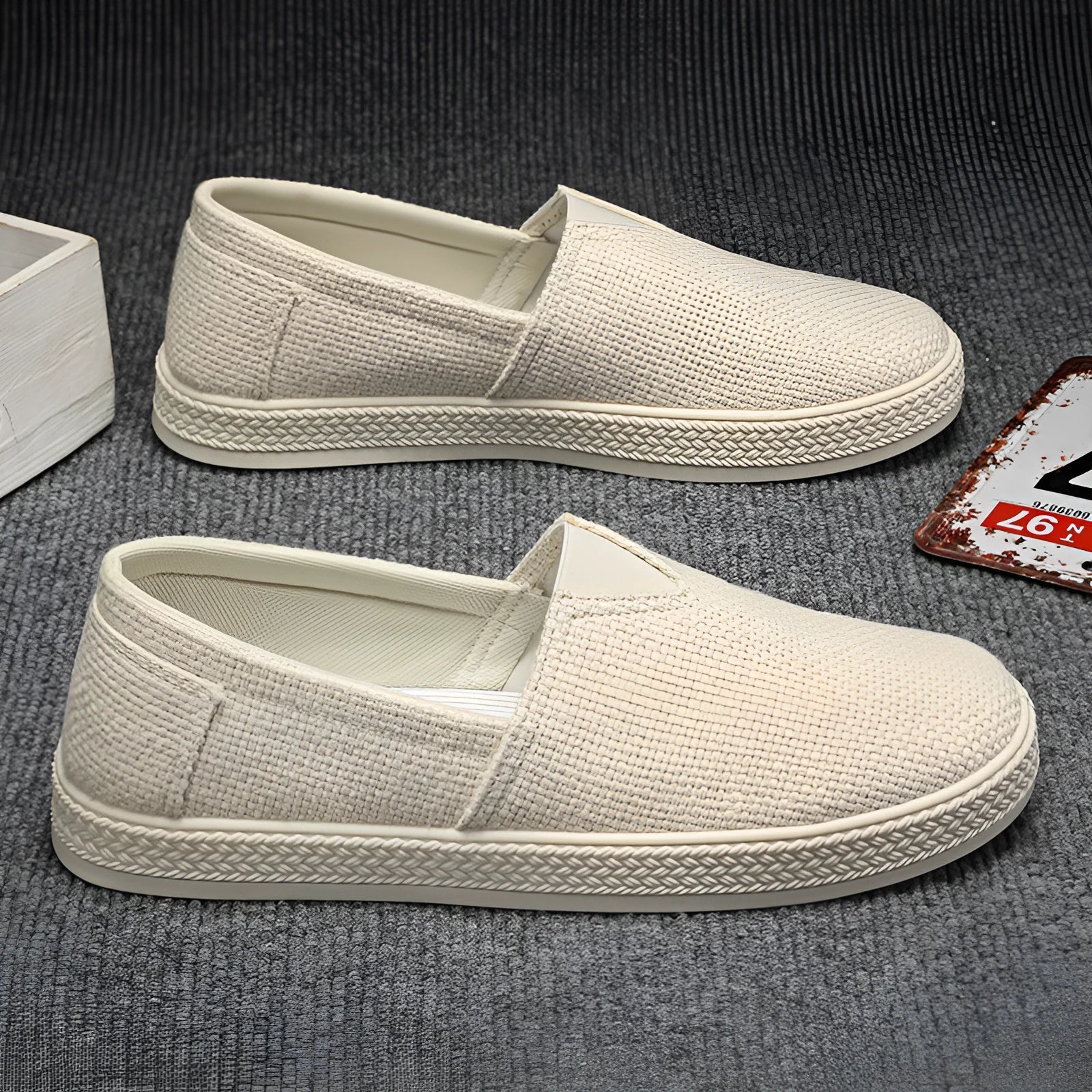 Men's beige linen cloth shoes with canvas upper and PVC sole on a plain background.