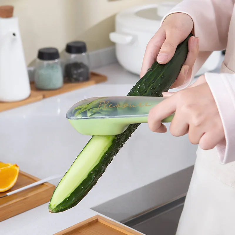 Dark green potato peeler with a removable storage tube and a stainless steel blade.