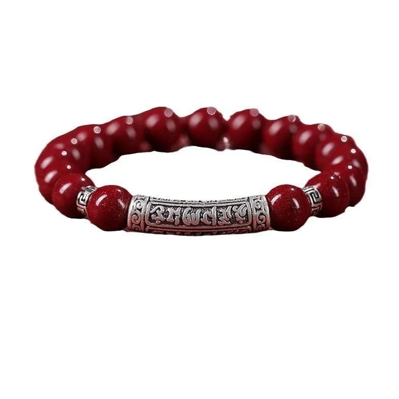 Handmade cinnabar sandstone bracelet in purple gold sand colour with 8mm beads on a wrist.