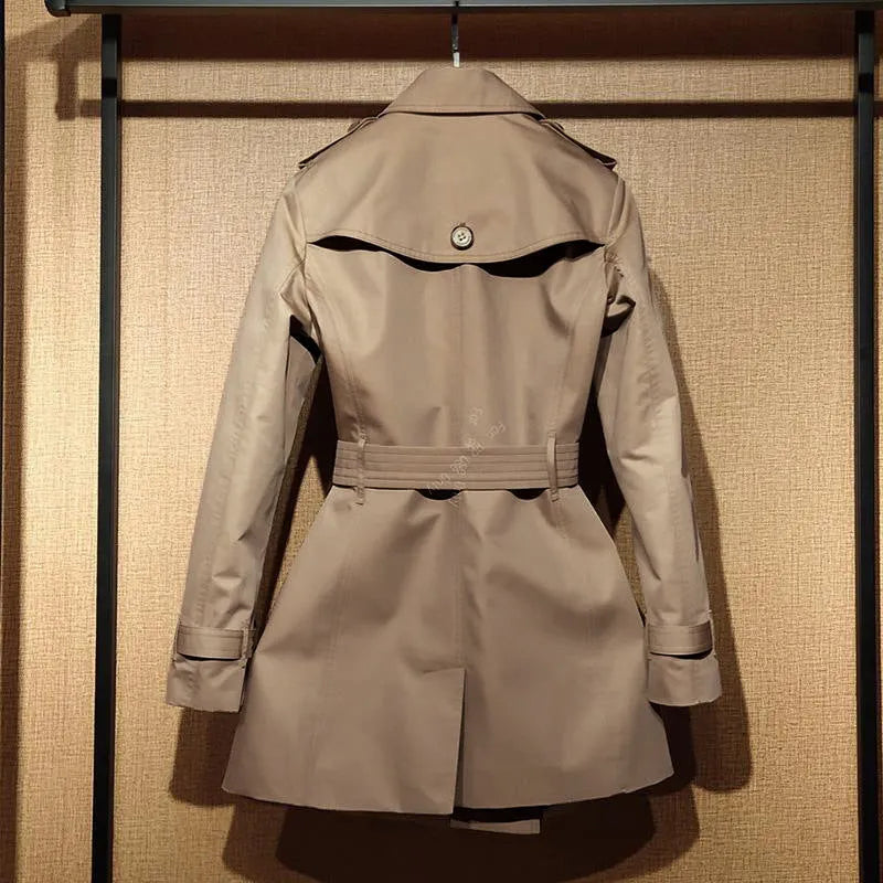 Khaki coloured women's double-breasted British-style trench coat with long flight sleeves.