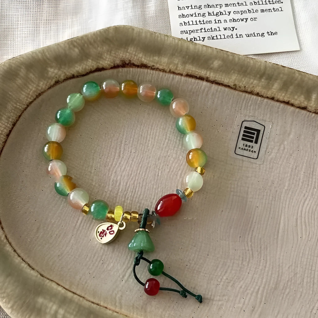 Close-up of a manually crafted lotus motif bracelet made from mixed materials in a national style.