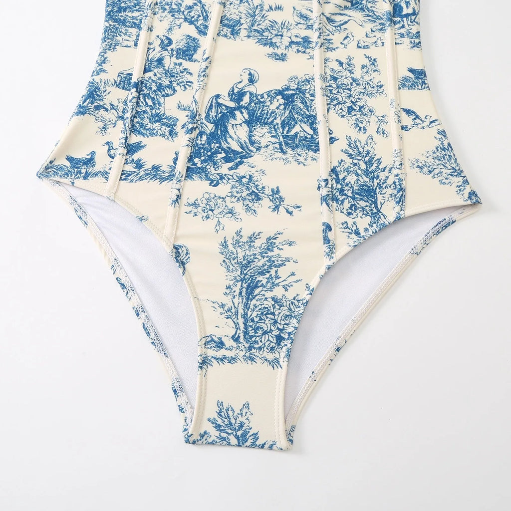 Blue patterned one-piece swimsuit for women with a matching gauze skirt.