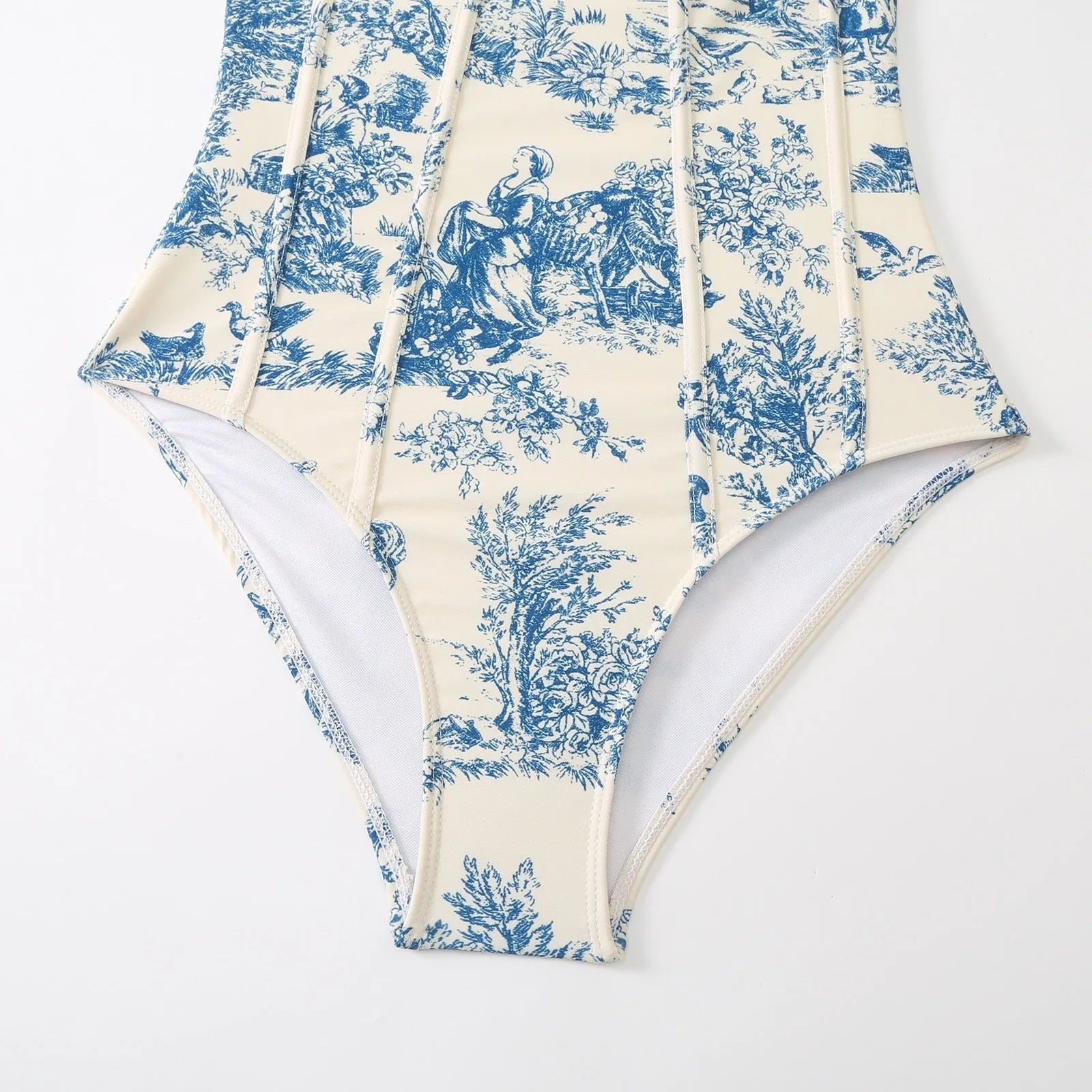 Blue patterned one-piece swimsuit for women with a matching gauze skirt.