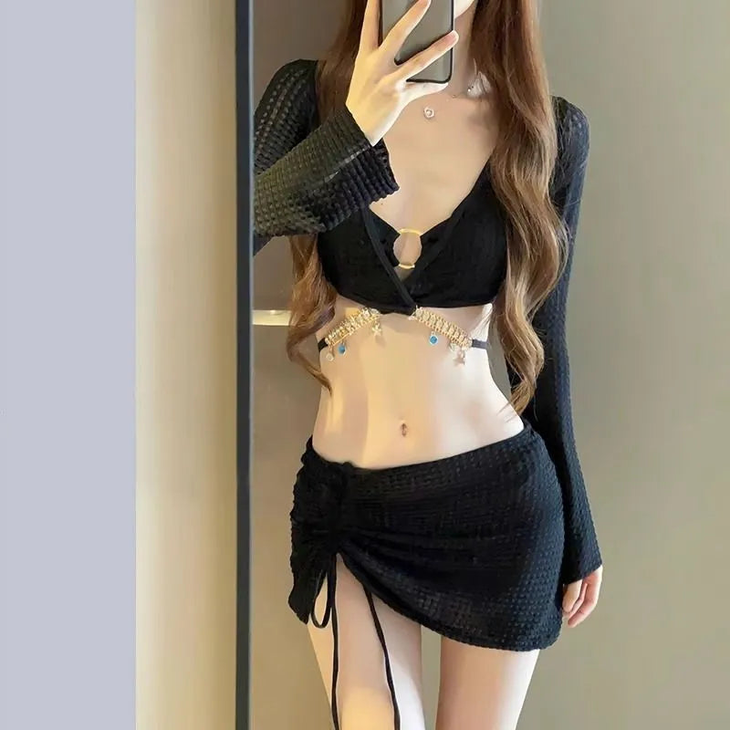Women's black long sleeve bikini swimsuit made from polyester fabric for swimming.