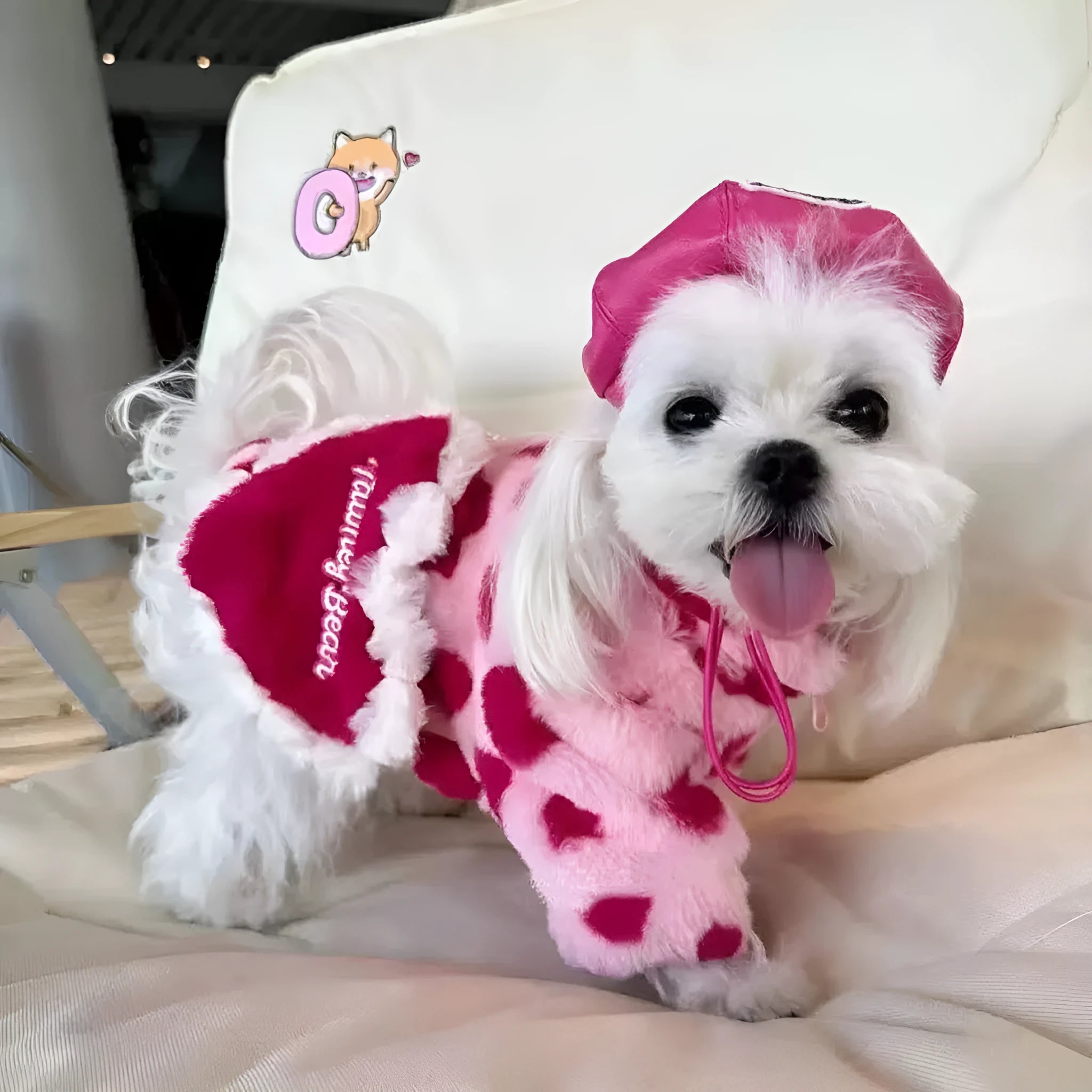 Small dog wearing pink polyester plush warm coat with British-style design