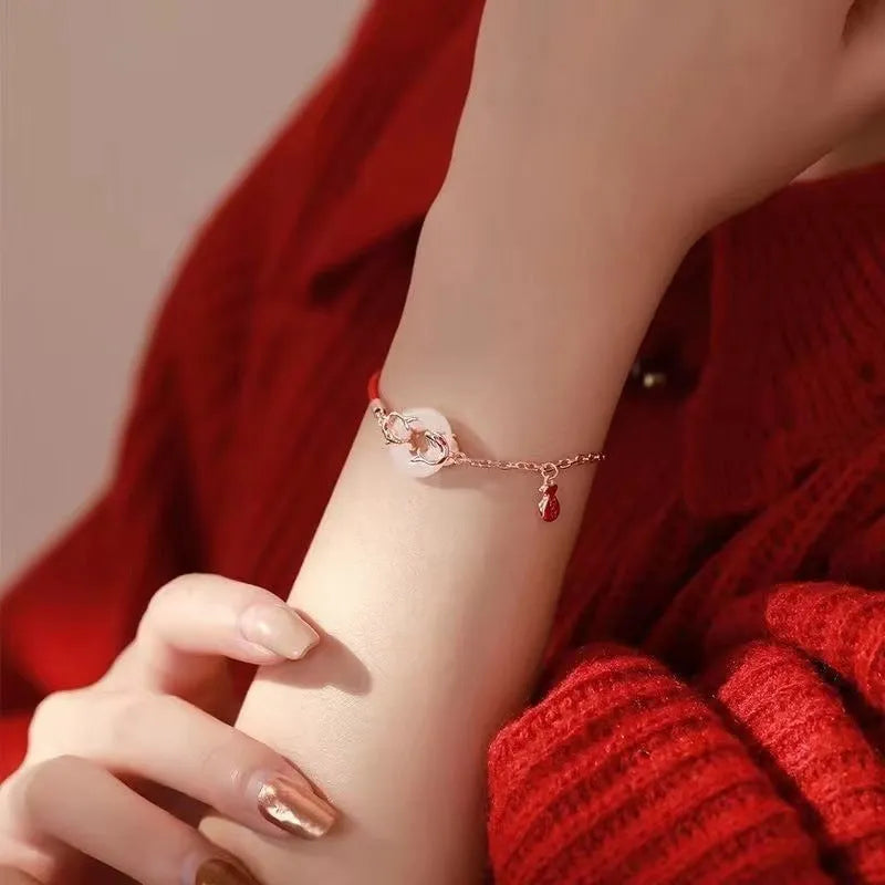 Festive koi bracelet with red rope adjustable closure and peace buckle on mixed materials