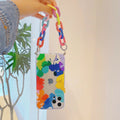 Personalised graffiti design TPU mobile phone case with a detachable wrist bracelet attached.