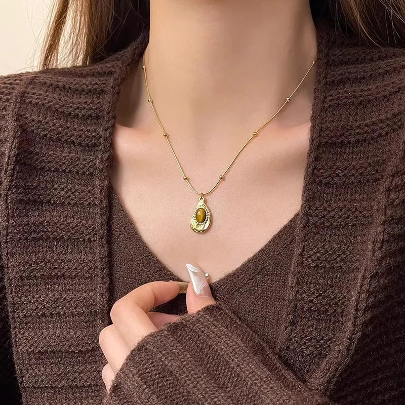 Gold titanium steel clavicle necklace with irregular amber tiger eye stone pendant