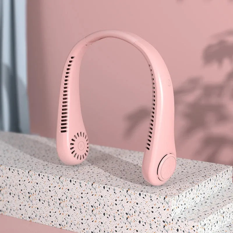 Blue bladeless neck fan hanging around a person's neck, showing the USB charging port and control buttons.