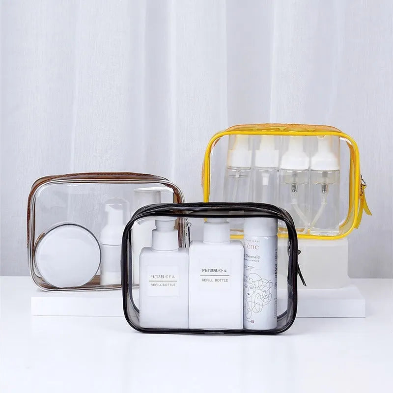 Set of three semi-transparent PVC makeup bags in black, pink, and white colours with handles
