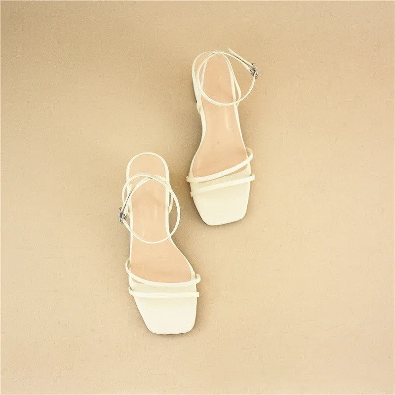 Beige women's stiletto sandals with a chunky heel, square toe, and an ankle buckle strap.