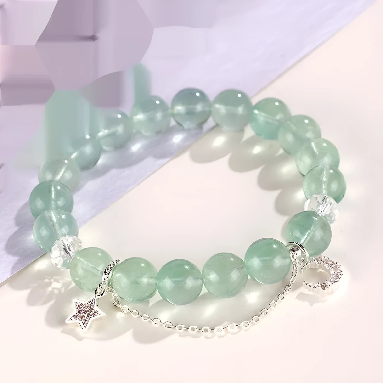 Green fluorite and white crystal star moon princess bracelet with electroplated setting and diamond-shaped stones.