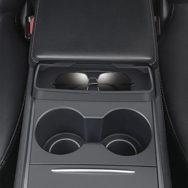 Black silicone sunglasses holder installed in Tesla centre console armrest compartment