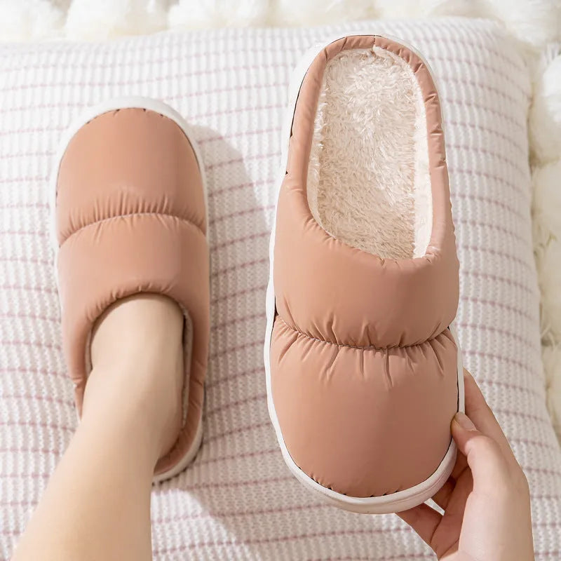 A pair of thick-soled down cotton slippers for men and women in a choice of colours, featuring a non-slip rubber sole.