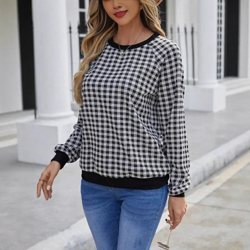 Black long sleeve polyester sweater with a plaid pattern, shown on a hanger.