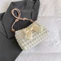 Street style canvas one-shoulder handbag in horizontal square shape with visible stitching.