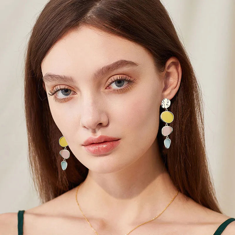 A pair of simple alloy disc earrings with a Morandi three-colour oil-drip finish on a vintage wafer design.