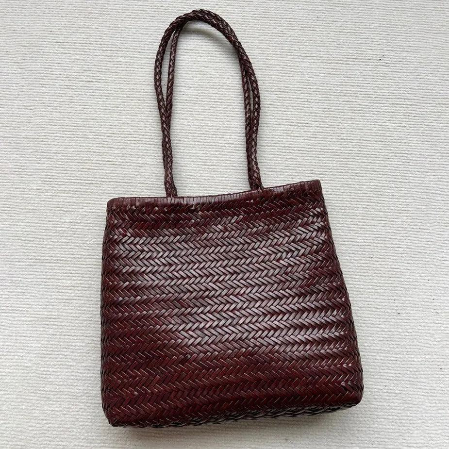 Handmade brown woven cowhide leather tote bag with a structured front pocket.