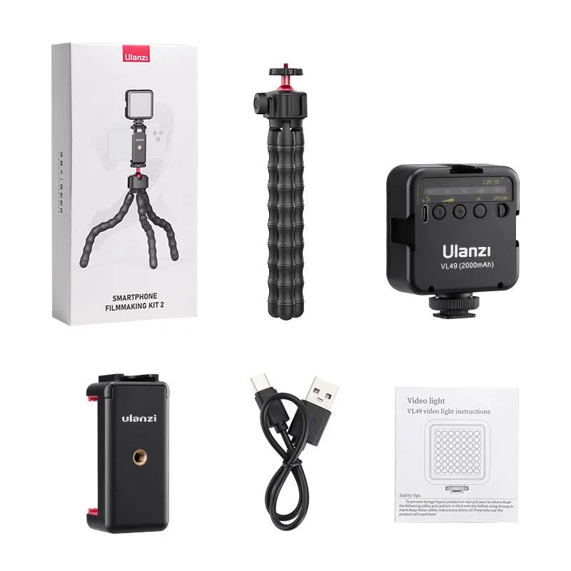 Multifunctional photography video vlog suite featuring an adjustable aluminium tripod on a flat surface.