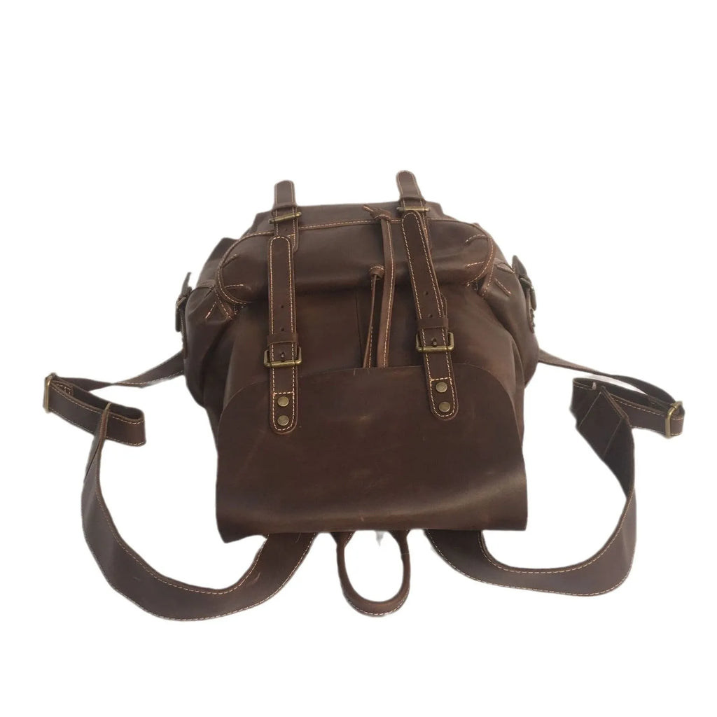 Brown men's leather backpack showing genuine cowhide material and integrated air pillow shoulder straps.