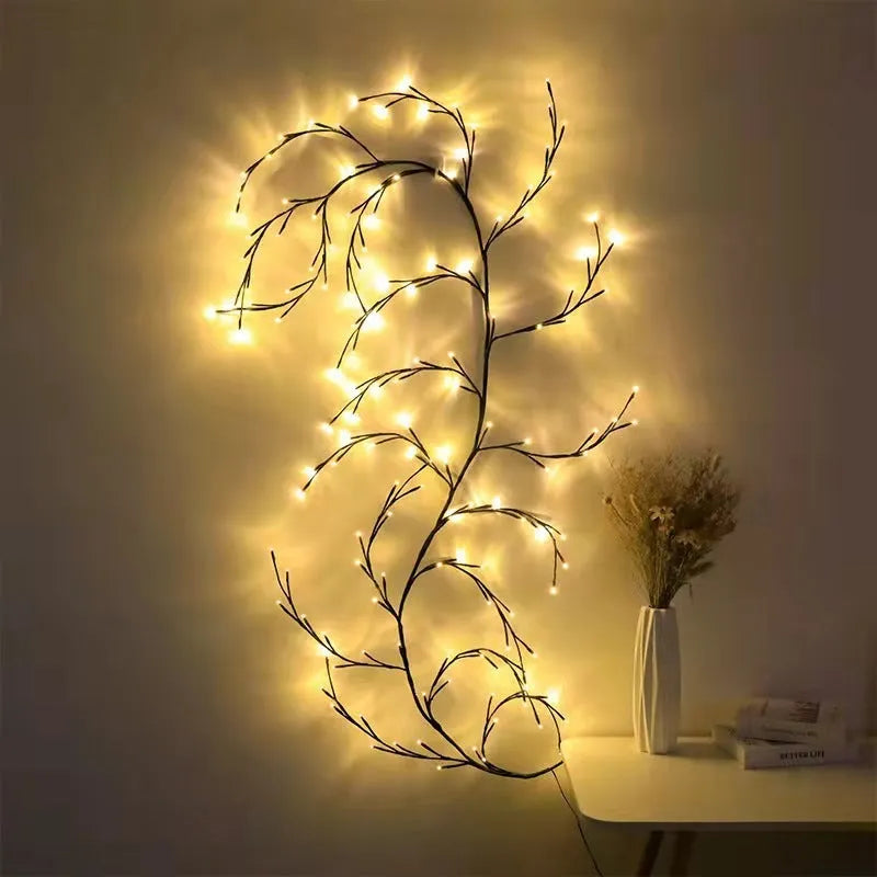 Flexible LED willow vine garland with warm white lights shaped into a decorative curve on a wall.