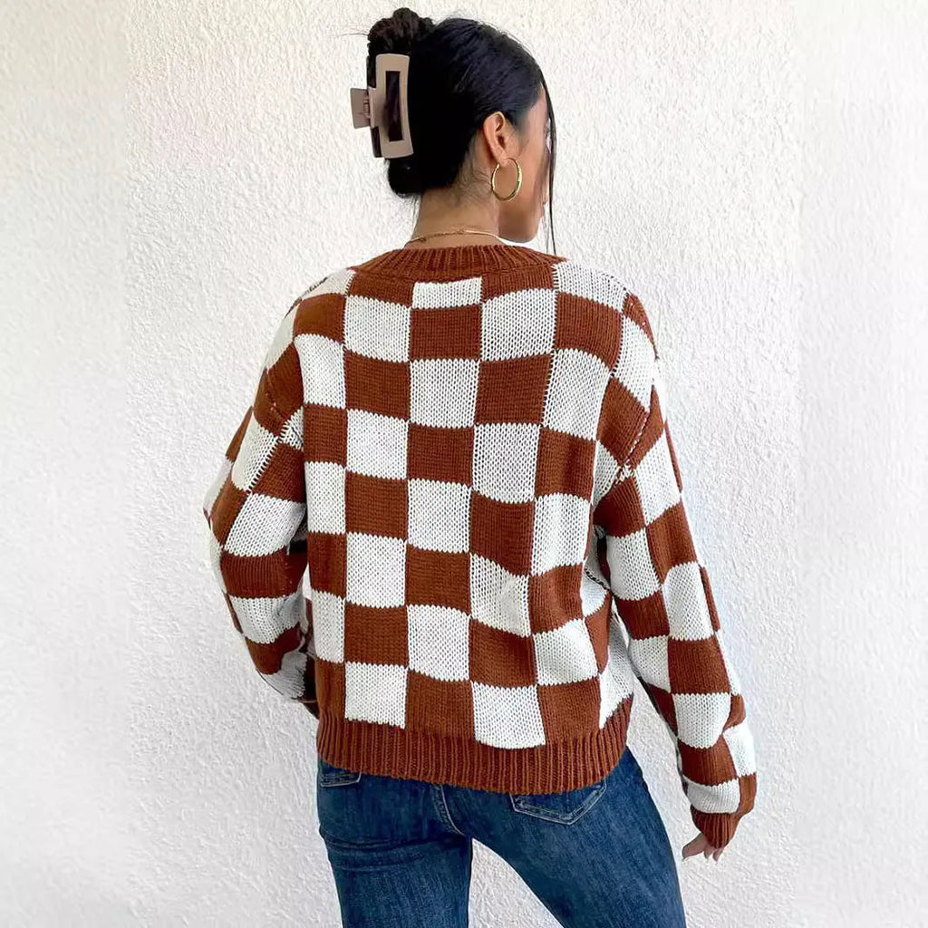 Dark brown plaid pattern long sleeve pullover sweater on a hanger.
