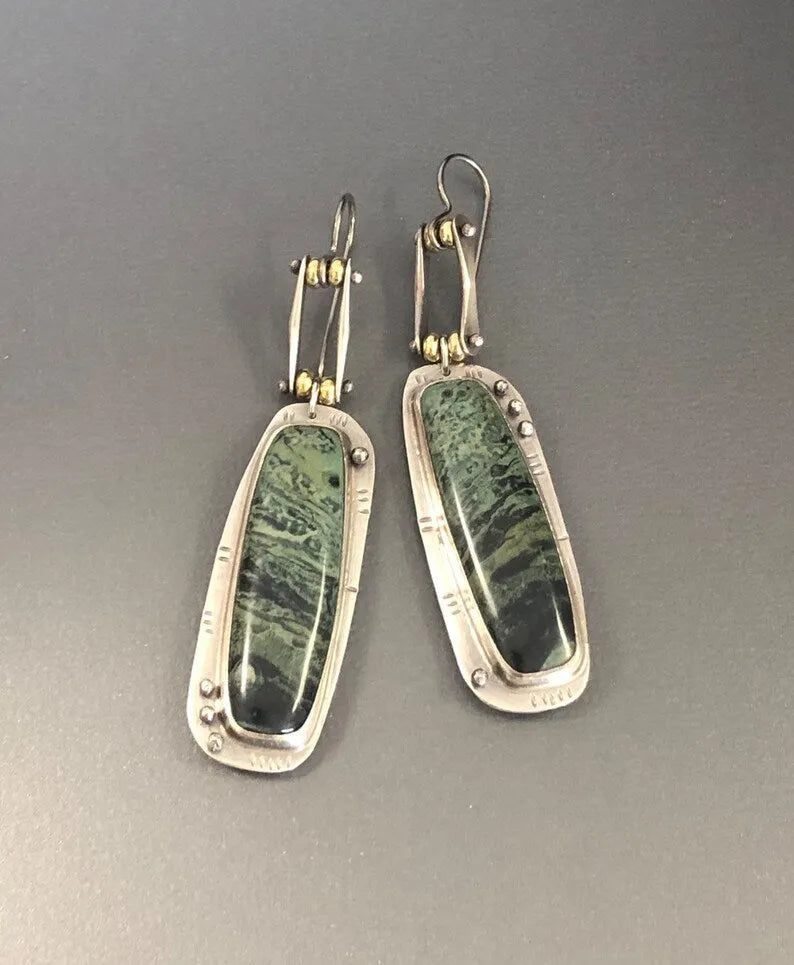 A pair of simple geometric drop earrings with a grey and white marble pattern on an alloy background.