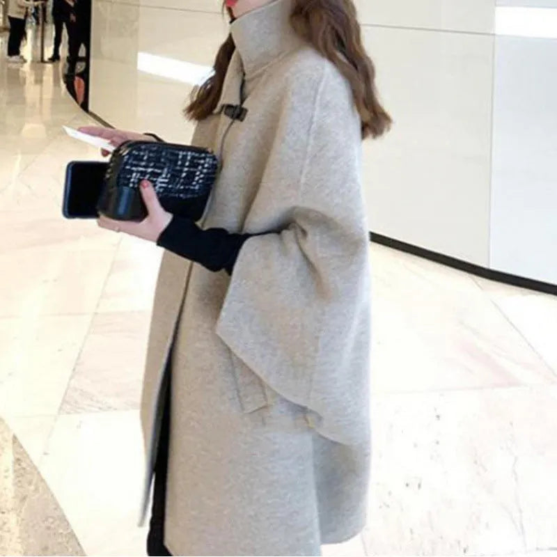 Korean-style women's long coat in oatmeal colour with flight sleeves, shown on a model.