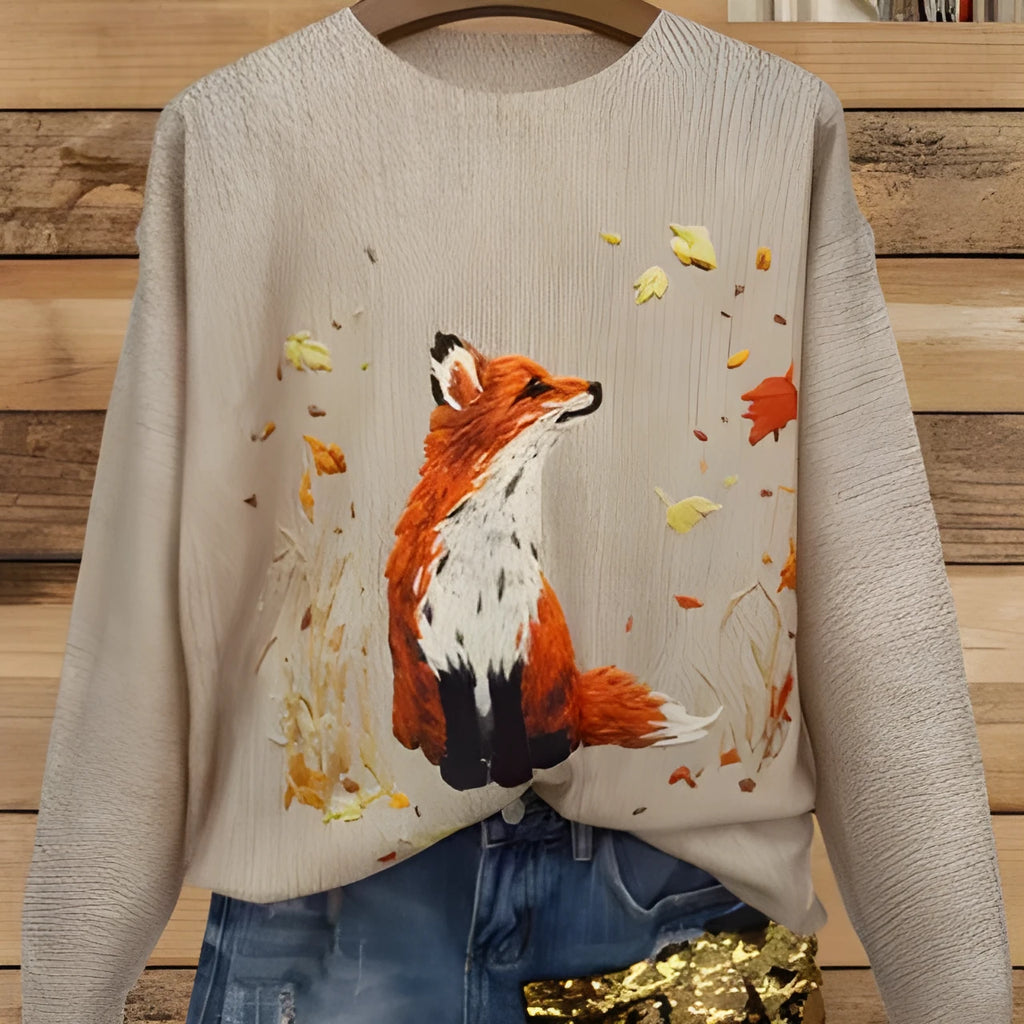 Loose-fit digital printed top with lapel collar on a hanger, shown in available sizes.