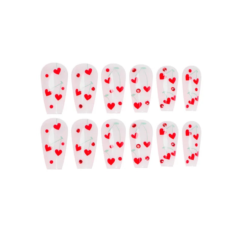 Red diamond and small cherry pattern nail art stickers on a sheet, with a tube of glue.