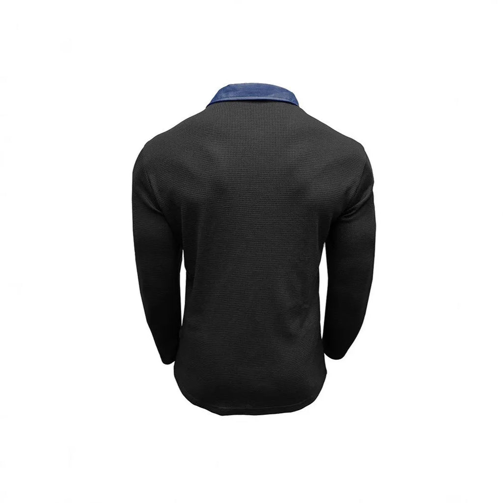 Man wearing a dark grey long-sleeved waffle-texture polo shirt with an asymmetric design detail.