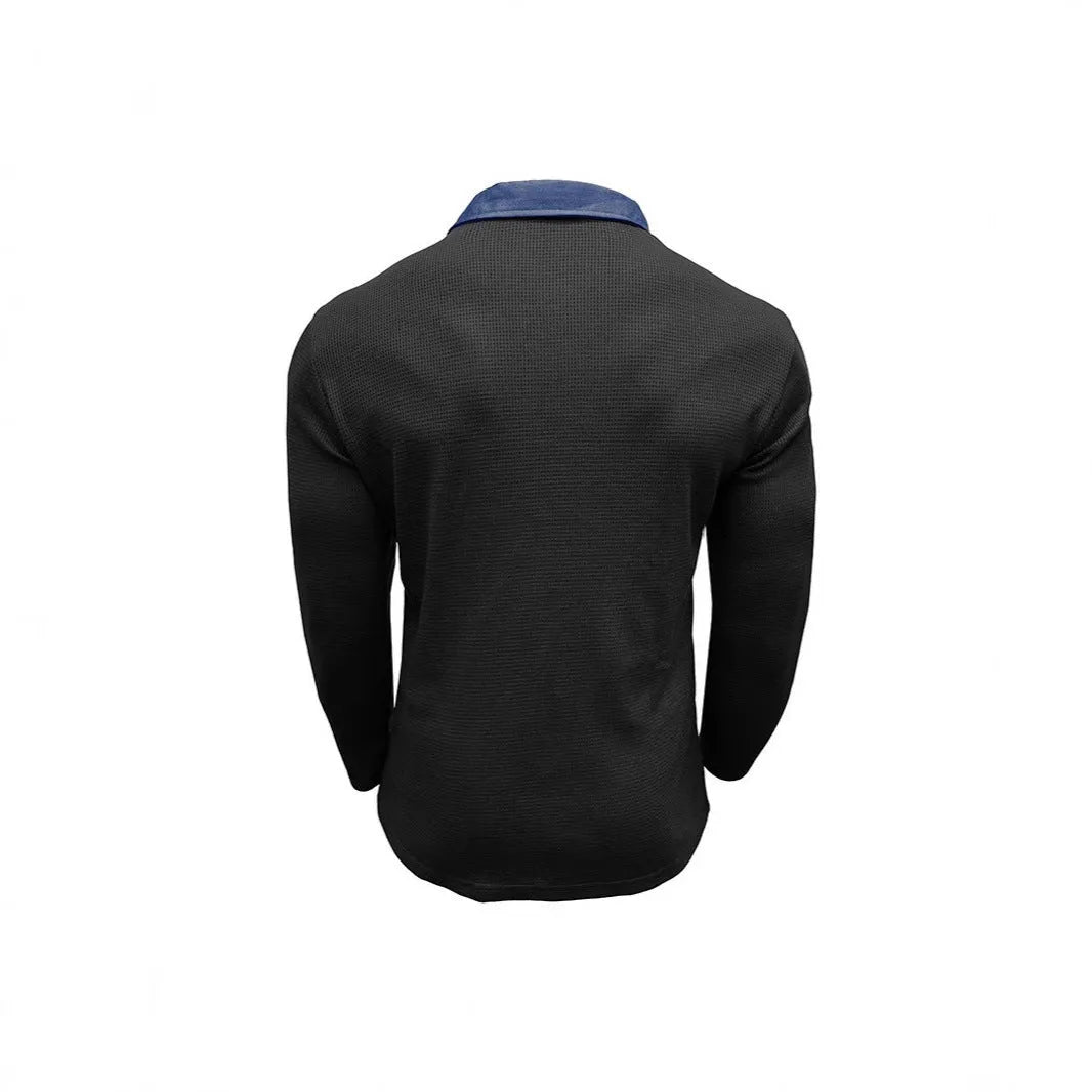 Man wearing a dark grey long-sleeved waffle-texture polo shirt with an asymmetric design detail.