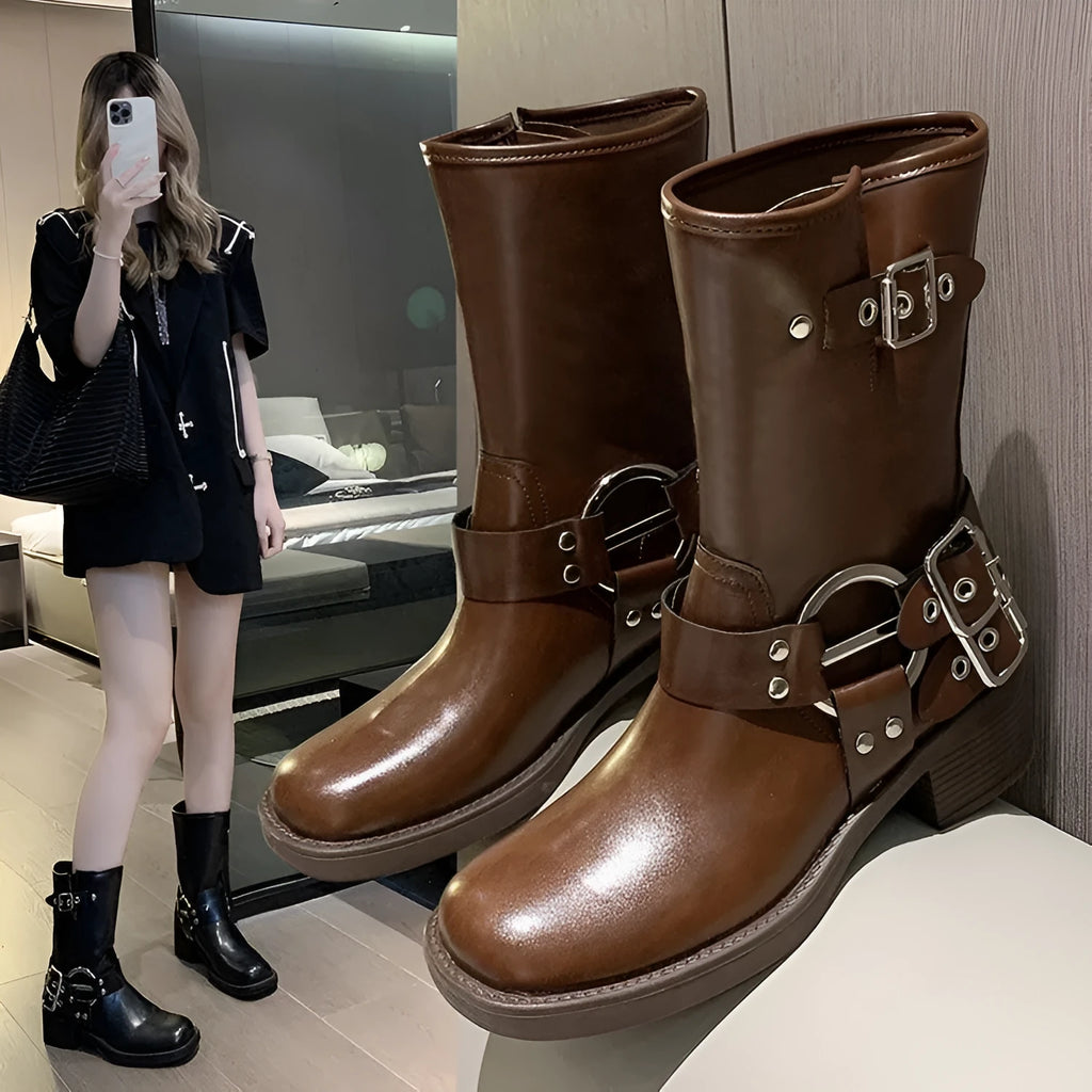 Women's black platform ankle boots with belt buckle detail and mid-calf length