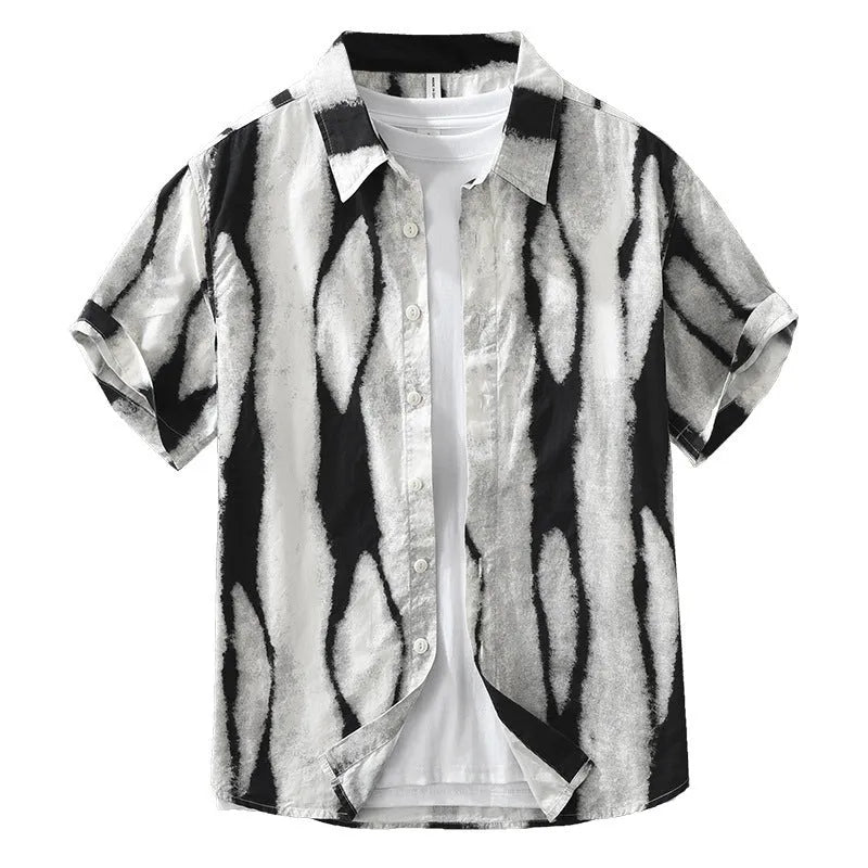 A man wearing a black and white striped loose-fit cotton cardigan-style short sleeve shirt.