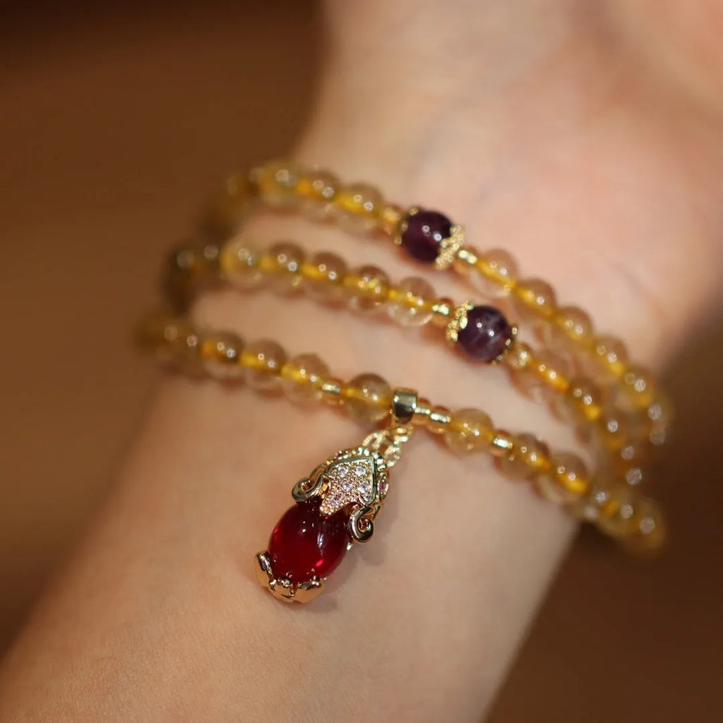 Natural Brazilian gold rutilated quartz bracelet with three gold beads and hanging chopsticks ornament