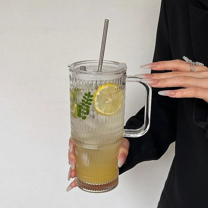 740ml round glass cup with handle, lid, and bent straw on modern table setting