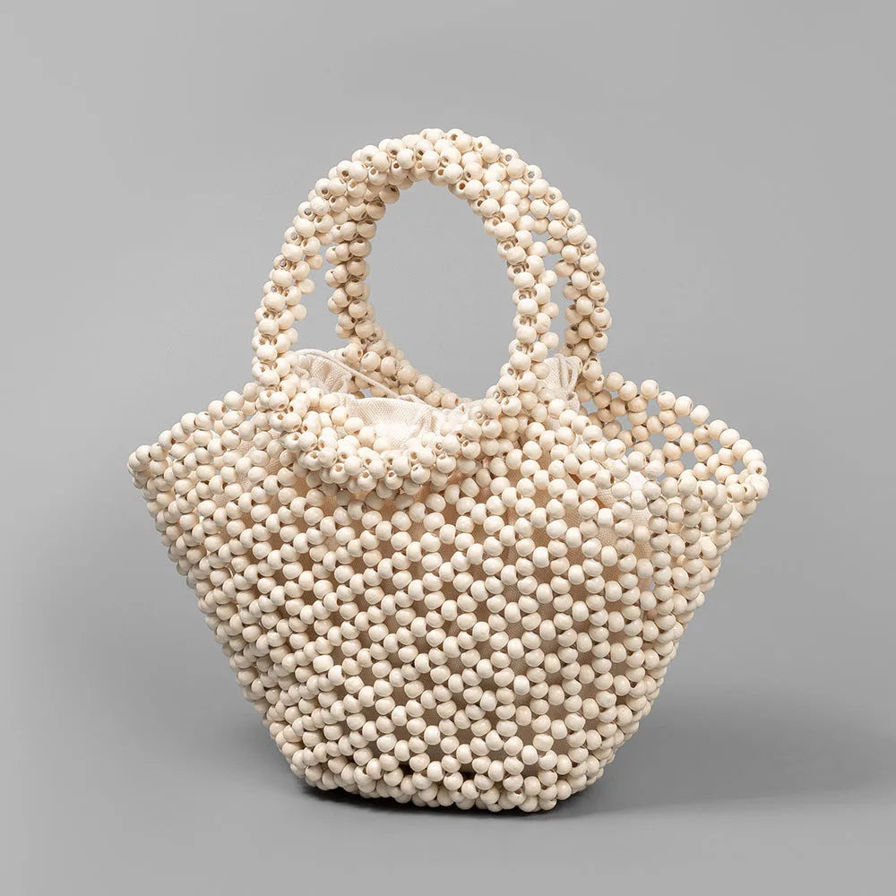 Hand-woven maple wooden bead beach bag in dumpling shape with hollow weave design