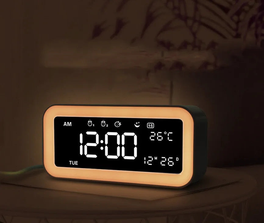 Blue rectangular LED alarm clock with digital display on a table.