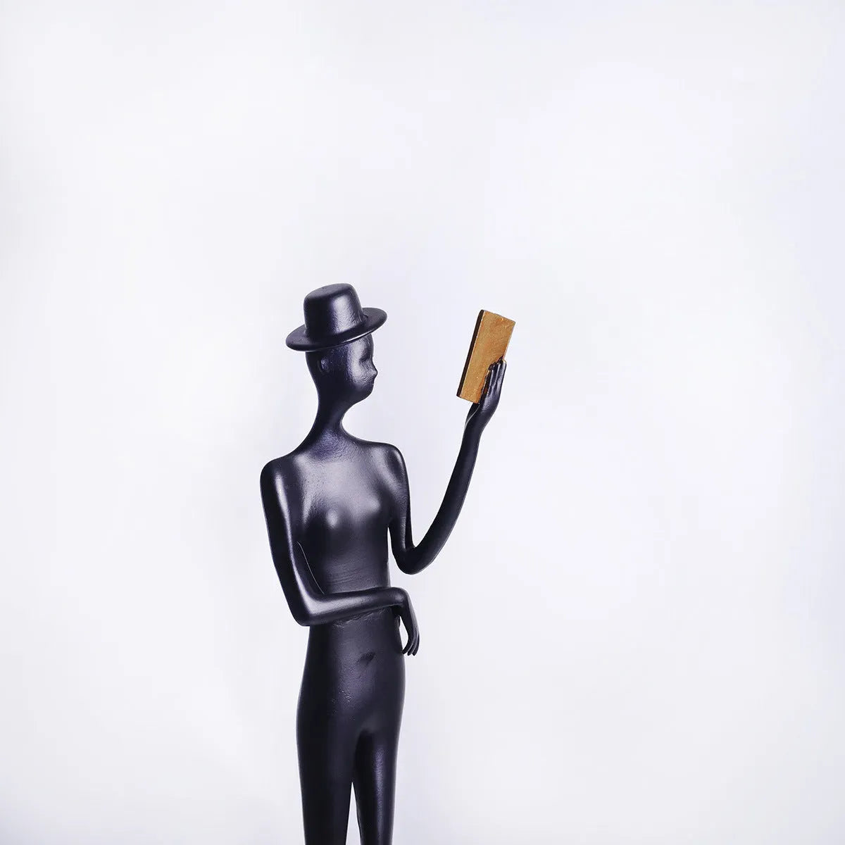 Black cast aluminium desktop sculpture of reading woman measuring 51 cm tall