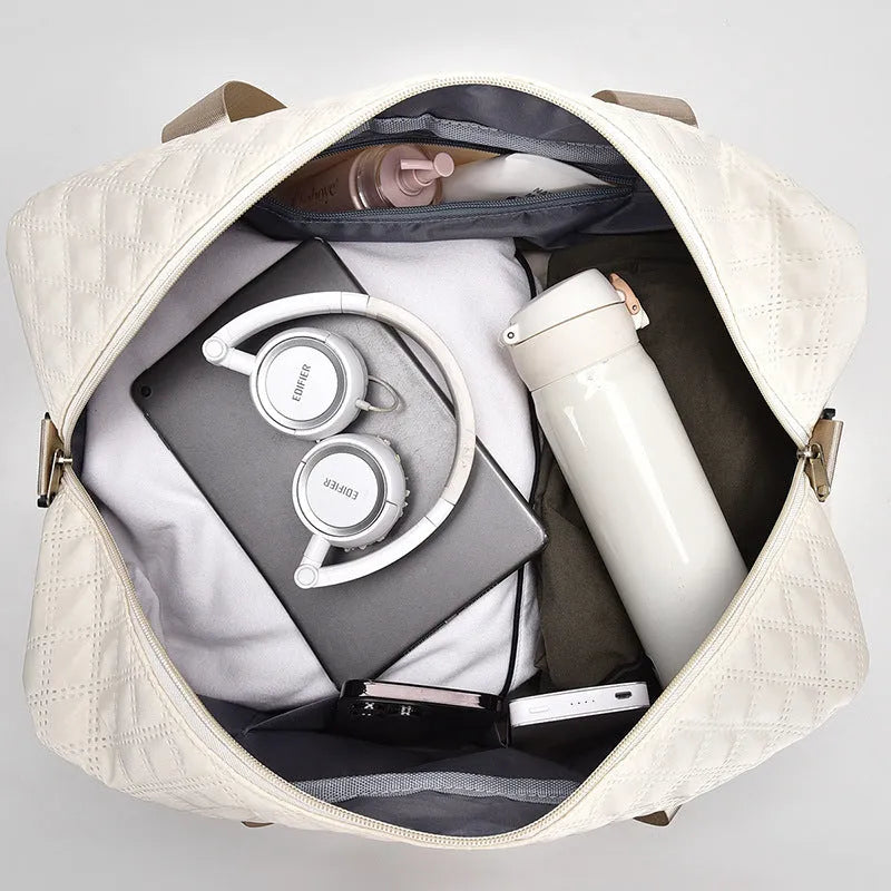 Large oxford cloth travel bag in a solid colour with visible sewing thread details, shown with the main compartment open.
