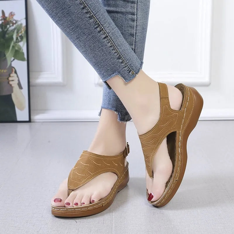 Women's red casual wedge heel sandals with an adjustable buckle strap on a white background.