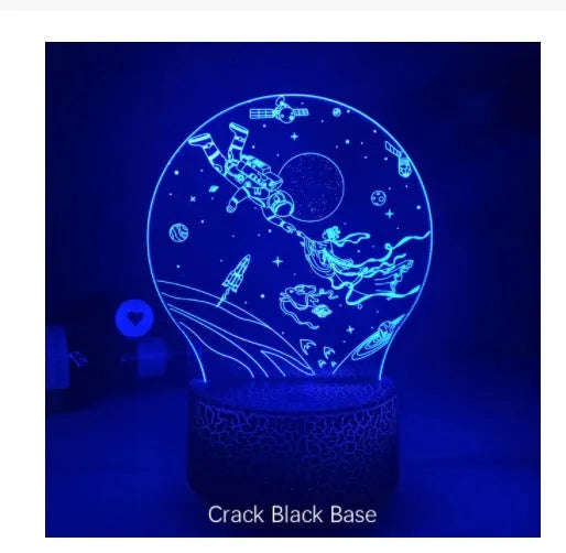 Colourful 3D night light in black base with remote control showing green glow on dark surface